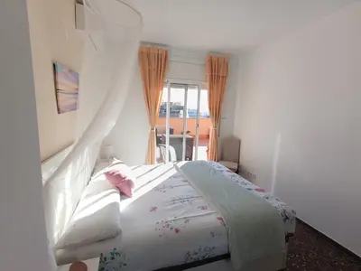 a bedroom with a bed and a window at Cozy and sunny penthouse Fira BCN in Hospitalet de Llobregat