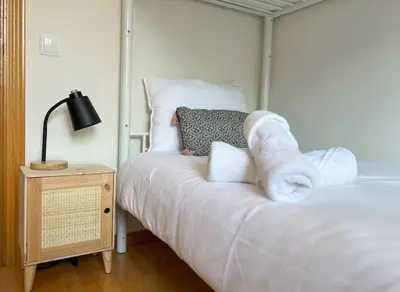 a bedroom with a bed with towels on it at Playa, piscina, parking GENIAL in Cubelles