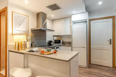a kitchen with a counter and a refrigerator at Canela Homes BARCELONA FLORIDABLANCA in Barcelona