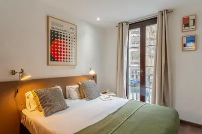 a bedroom with a bed and a large window at Canela Homes BARCELONA FLORIDABLANCA in Barcelona