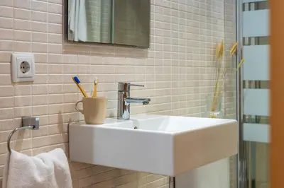 a bathroom with a sink with toothbrushes in it at Canela Homes BARCELONA FLORIDABLANCA in Barcelona
