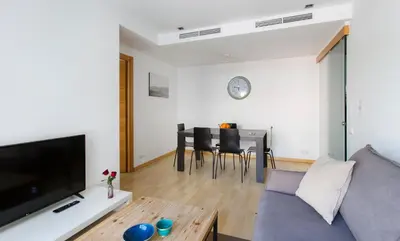 a living room with a couch and a table at Durlet Rambla Mar Apartments in Barcelona