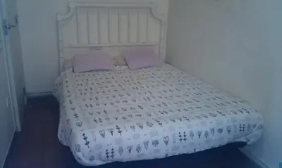 a bed with two purple pillows on top of it at Holiday home La casa azul in Barcelona