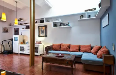 a living room with a couch and a table at Holiday home La casa azul in Barcelona