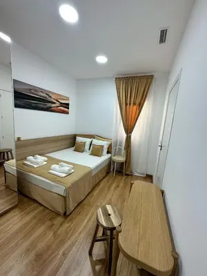 a bedroom with a bed and a desk and a table at MI CASA ES TU CASA in Hospitalet de Llobregat