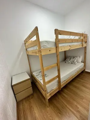 a wooden bunk bed in a room at MI CASA ES TU CASA in Hospitalet de Llobregat
