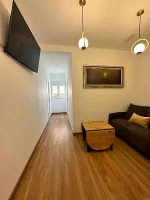 a living room with a couch and a table at MI CASA ES TU CASA in Hospitalet de Llobregat
