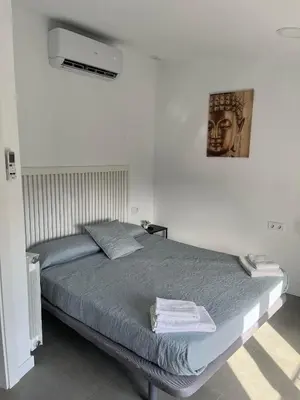 a bedroom with a bed with towels on it at Hostal La Masia in Manresa