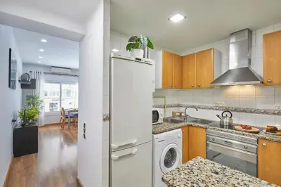 a kitchen with a white refrigerator and a dishwasher at BBarcelona Gràcia Nova Flat in Barcelona