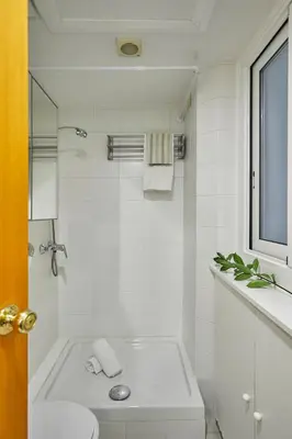 a white bathroom with a toilet and a sink at BBarcelona Gràcia Nova Flat in Barcelona