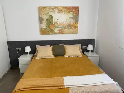 a bedroom with a bed with two night stands at Cal Sidru Castellolí in Castellolí