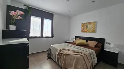 a bedroom with a bed and a window at Cal Sidru Castellolí in Castellolí