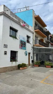 a bedroom with a bed with two towels on it at Sitges Beach Hostal in Sitges