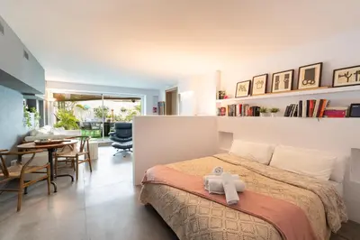 a bedroom with a bed with a towel on it at Sitges Beach Hostal in Sitges