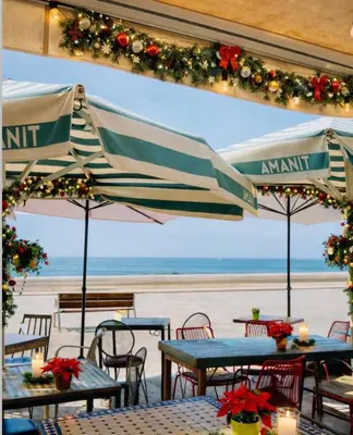a white couch with two pillows on it at Sitges Beach Hostal in Sitges