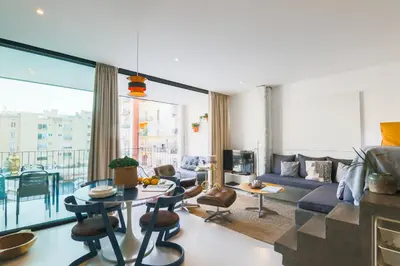 a living room with a couch and a table at En Ville Boutique Apartments Sant Antoni in Barcelona