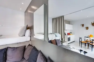 a bedroom with a bed and a living room at En Ville Boutique Apartments Sant Antoni in Barcelona