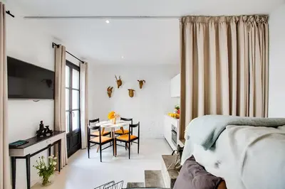 a bedroom with a bed and a table and chairs at En Ville Boutique Apartments Sant Antoni in Barcelona