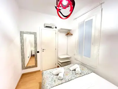 a bedroom with a bed and a mirror at Apartment carrer d'Olesa in Barcelona