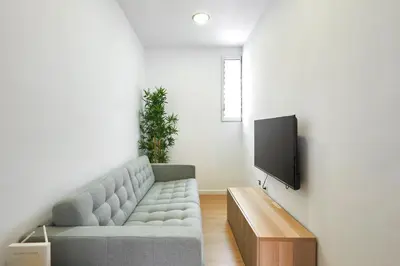 a living room with a couch and a tv at Ma Bright apartment next to Parc de Montjuïc in Barcelona
