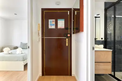 a bathroom with a door leading to a bedroom at Ma Bright apartment next to Parc de Montjuïc in Barcelona