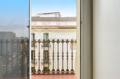 a view of a building from a window at Ma Bright apartment next to Parc de Montjuïc in Barcelona
