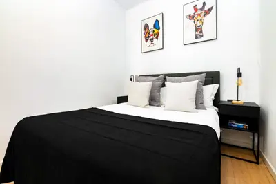 a bedroom with a bed with a black blanket at R&B Mila in Barcelona