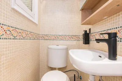 a bathroom with a sink and a toilet at R&B Mila in Barcelona