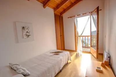 a bedroom with a bed and a large window at Swiss style villa near Barcelona 10min to beach in Sant Cebrià de Vallalta