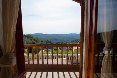 a view from a porch with a view of the mountains at Swiss style villa near Barcelona 10min to beach in Sant Cebrià de Vallalta