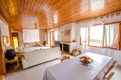 a living room with a table and a couch at Swiss style villa near Barcelona 10min to beach in Sant Cebrià de Vallalta
