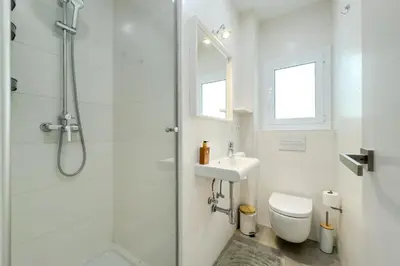 a bathroom with a shower and a toilet and a sink at Barcelona Amelie Apartment in Hospitalet de Llobregat