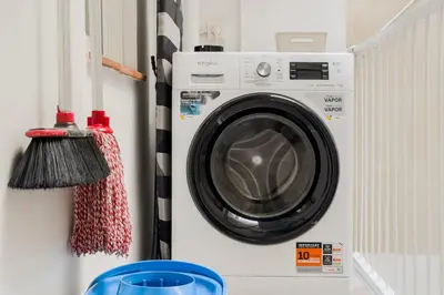 a washer and dryer in a room with a wall at Barcelona Aura Apartments in Hospitalet de Llobregat
