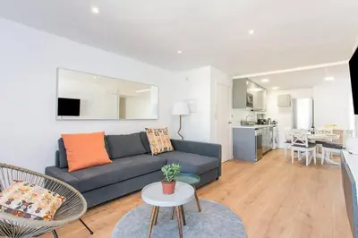 a living room with a couch and a table at Canela Homes COSTA CALMA in Castelldefels