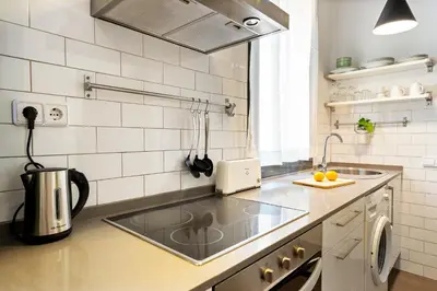 a kitchen with a sink and a counter top at Lodging Apartments Almirall Beach 41 in Barcelona