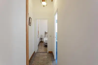 a hallway with a door leading to a room with a bed at Canela Homes BARCELONA JOVELLANOS in Barcelona