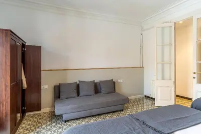 a bedroom with a bed and a couch at Canela Homes BARCELONA ESSENCE in Barcelona