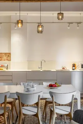 a white kitchen with a white table and chairs at Canela Homes BARCELONA ESSENCE in Barcelona