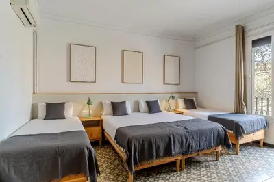 a bedroom with two beds and a window at Canela Homes BARCELONA ESSENCE in Barcelona
