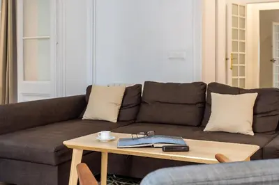 a living room with a brown couch and a coffee table at Canela Homes BARCELONA ESSENCE in Barcelona