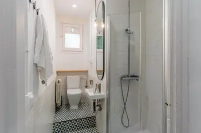 a bathroom with a toilet and a sink and a shower at Canela Homes BARCELONA ESSENCE in Barcelona