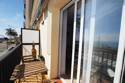 a balcony with a bench and a view of the ocean at Cami Ral in Premiá de Mar