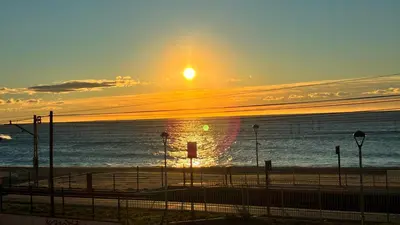 a sunset over a beach with the ocean at Cami Ral in Premiá de Mar