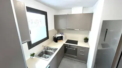 a small kitchen with a sink and a window at APARTAMENTO CON TERRAZA BY PRESTIGI in Terrassa