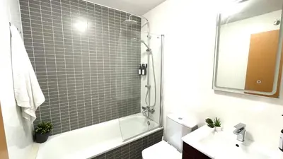 a bathroom with a shower and a toilet and a sink at APARTAMENTO CON TERRAZA BY PRESTIGI in Terrassa