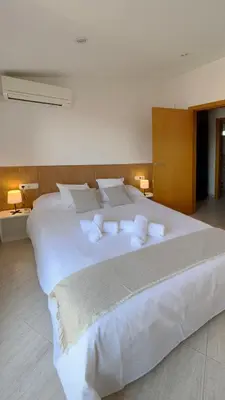 a large white bed with white pillows on it at M3 Céntrico y con Terraza in Terrassa