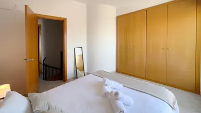 a bedroom with a bed with towels on it at M3 Céntrico y con Terraza in Terrassa