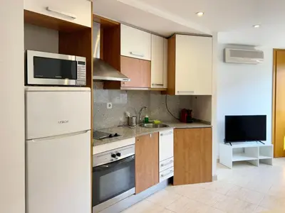 a kitchen with white cabinets and a microwave at M3 Céntrico y con Terraza in Terrassa