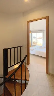 a view of a bedroom with a bed and a doorway at M3 Céntrico y con Terraza in Terrassa