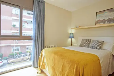 a bedroom with a bed and a large window at Winahost La Terraza de Sant Cugat in Sant Cugat del Vallès
